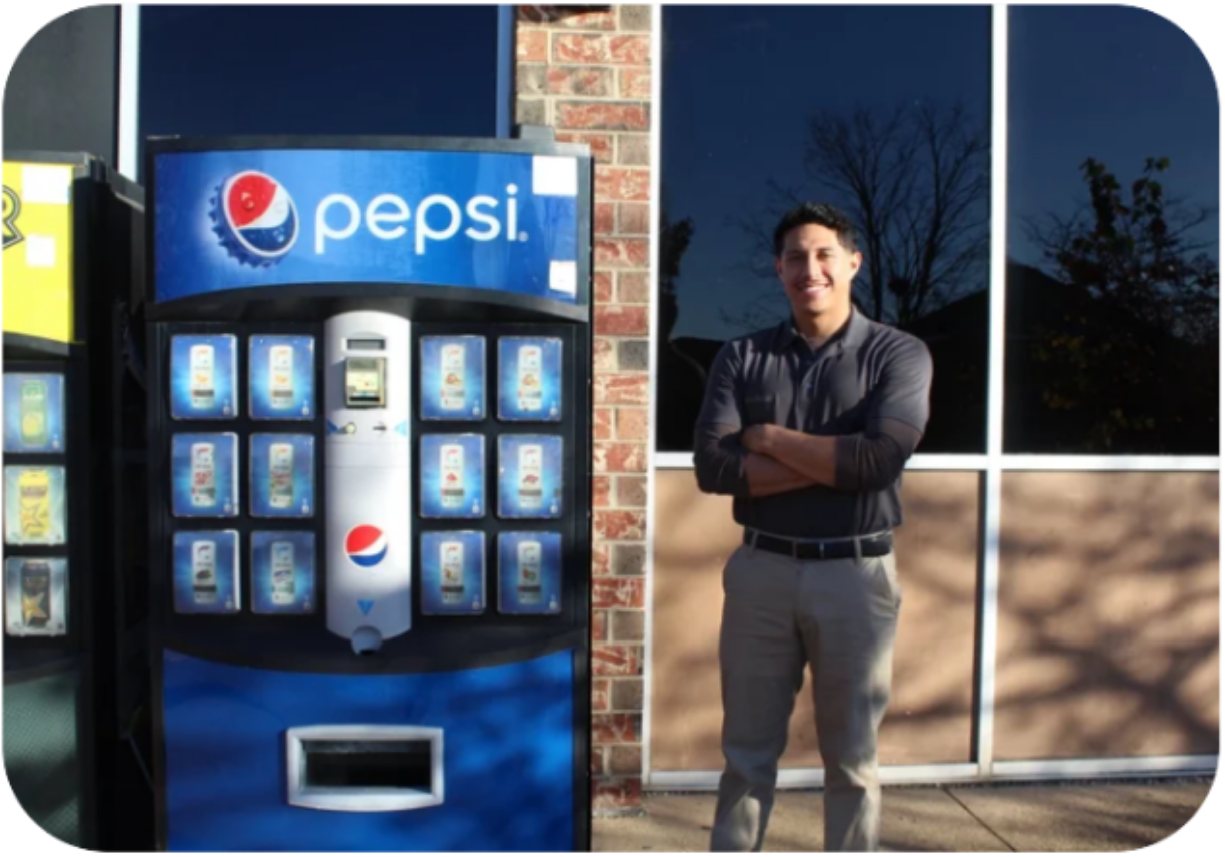 The VendiSphere owner standing beside an installed vending machine